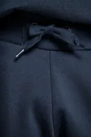 Pantaloni unisex Kariban Jogging Bottoms personalizați, pe model